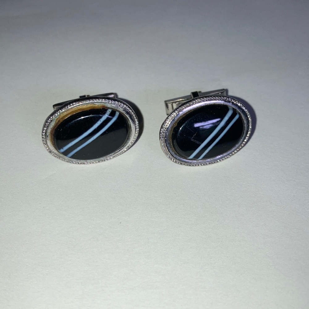 Z178-Cuff links that are oval shaped silver, black with two white stripes.